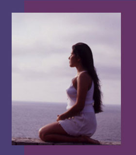 Serene woman meditating on the beach - Spiritual Life Coach